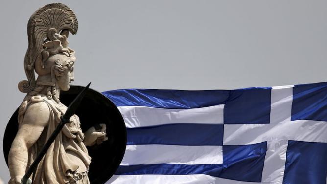 A Greek national flag flutters next to a statue of ancient Greek goddess Athena, in Athens May 21, 2015.  REUTERS/Alkis Konstantinidis